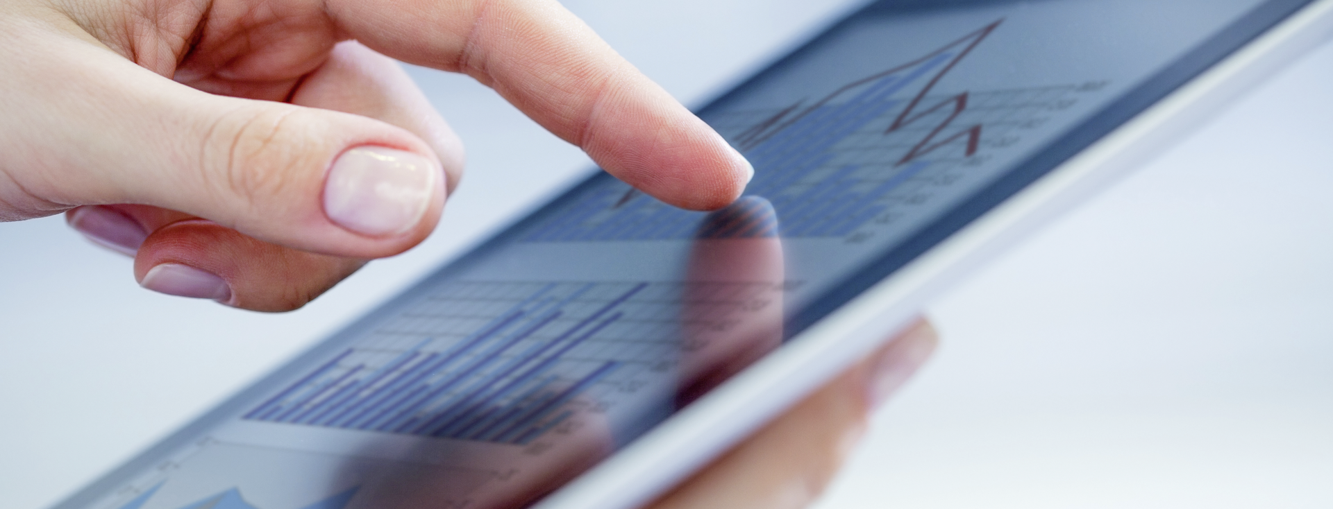 finger tapping on the touchscreen of a tablet