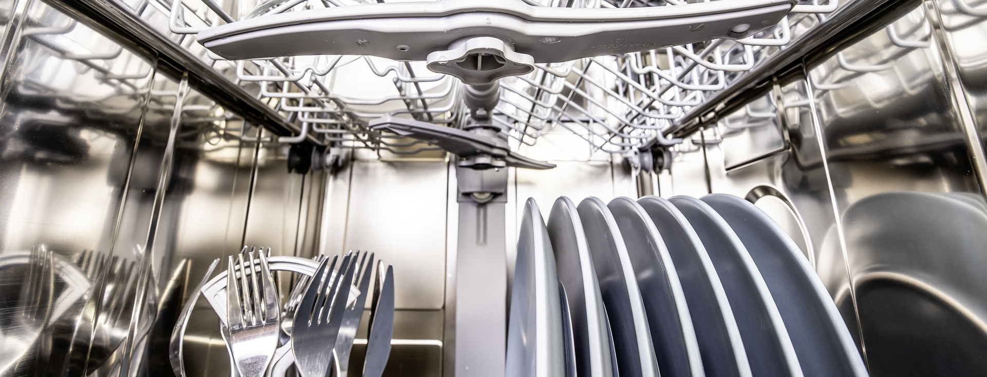 Inside view of a loaded dishwasher with clean dishes Inside view of a loaded dishwasher with clean dishes